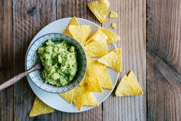 Guacamole fait maison avec des tortillas chips de maïs - Préparation traditionnel mexicaine épicée