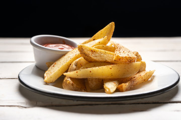 French fries with ketchup sauce on white background