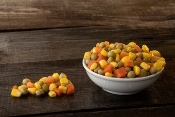 White plate on rustic table with vegetables.
