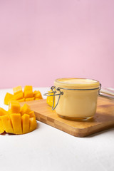 Mango yogurt in glass pot