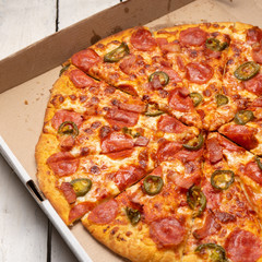Mexican pizza with jalapeno pepper and bacon on white background