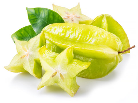 Carambola fruit with slice of star fruit and leaves isolated on a white background.