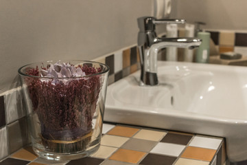 Bathroom interior with white sink and flowers