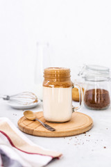 Trendy dalgona coffee in glass on white background.Korean drink latte espresso with foam of instant coffee. New popular food and drink trend. Selective focus
