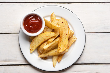 French fries with ketchup sauce on white background