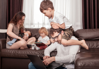 Father works at home. Full family stay home. Father freelancer try to work at home with children.