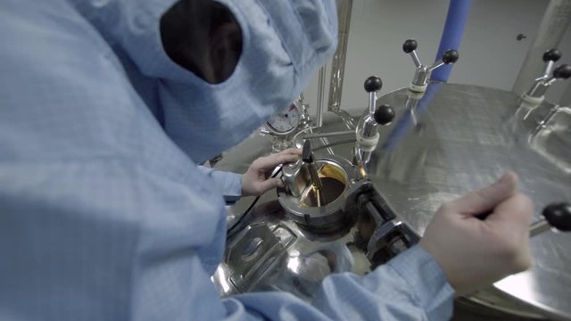 operator monitoring production of medical solutions medical industry