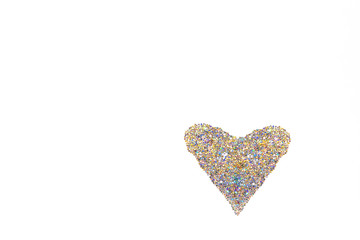 Heart made of sparkles and tinsel on the white background