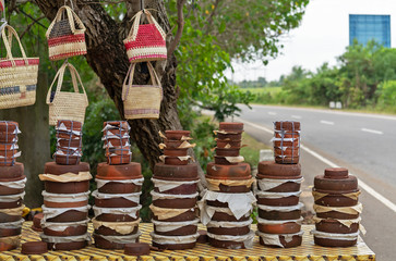 Street food on Sri Lanka road, ceramic bowls with traditional sweets - buffalo curdled milk