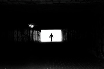 Light at End of Tunel and Silhouette of Man - obrazy, fototapety, plakaty