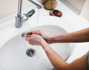 Washing hands rubbing with soap man