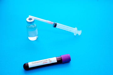 Coronavirus Covid-19 outbreaking. Medicine and epidemic concept. Tube with positive blood test result, protective face mask, medication pills, stethoscope, vial and syringe, vaccine in laboratory