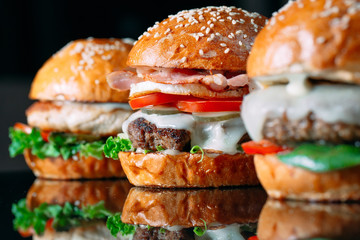 Juicy beef Burgers on a black background.