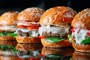 Juicy beef Burgers on a black background.