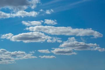 white Cumulus clouds in a blue sky