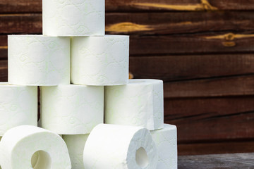 wooden background in retro style on it lined with pyrimide toilet paper