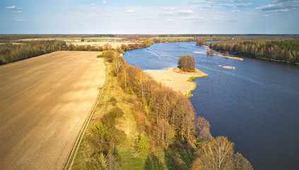 Spring windy day. Ripples on the water. River with island aerial view.