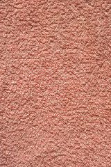 flat pink salmon color fabric surface of a soft towel - closeup background texture material