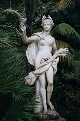 The sculpture of Ceres among fern in the park of Quinta da Regaleira. Sintra. Portugal