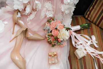 Wedding rings and other accessories close-up during the bride's gathering. Wedding