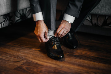 A stylish man wears classic shoes close-up. Fashion