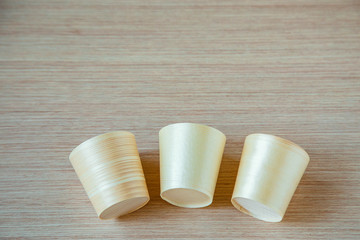 eco-friendly, disposable tableware, without plastic, on a light wooden background