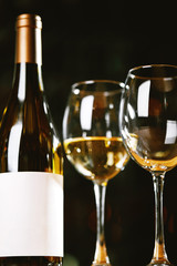 Bottles and glasses with wine on the table. Wine drinking culture concept. Apperetes and survivors. Copy space, dark background