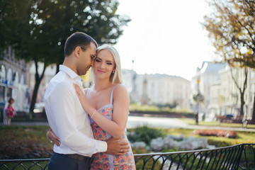 Obraz premium walking down the street together. Happy young man and smiling woman walking through the streets of Old Town,