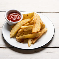 French fries with ketchup sauce on white background