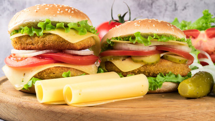 two hamburgers on a gray background