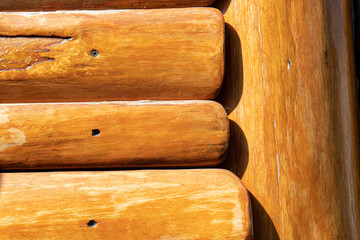 Log house background, wooden boards varnished, wall of wooden house. Wooden texture