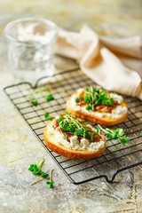 Canape or crostini with toasted baguette, cottage cheese, fig jam