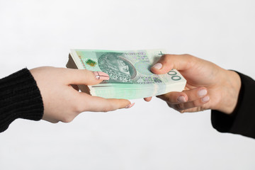 The businesswoman hands a bundle of banknotes as an additional bonus to the salary.