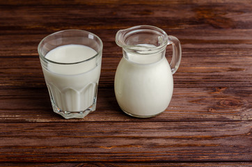 Homemade fermented beverage in a glass of kefir on a wooden background.