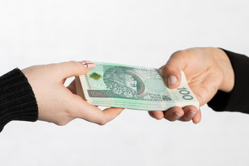 The businesswoman hands a bundle of banknotes as an additional bonus to the salary.