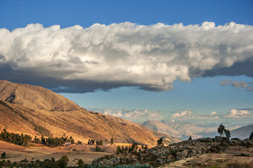 Fototapeta na wymiar Andes mountains beautiful landscape in a sunny day with white clouds, near sacred valley in Csuco, Peru.