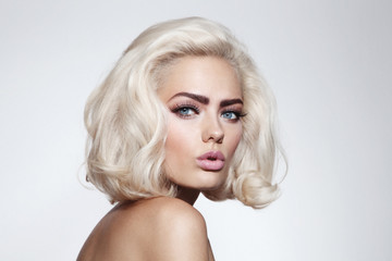 Naklejka premium Vintage style portrait of young beautiful blonde girl with fancy makeup