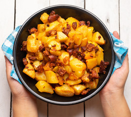 Mexican potatoes with chorizo on white background