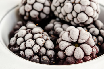 Frozen blackberries on a white background. Close up, season concept, season.