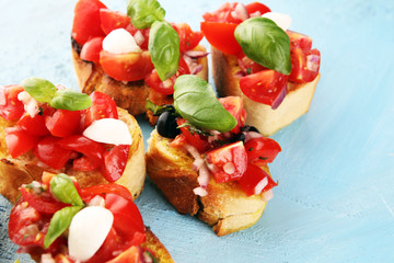 Traditional italian bruschetta with cherry tomatoes, cream cheese, basil leaves on rustic...
