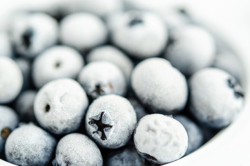 Frozen blueberries on a white background. Close up, season concept, season.