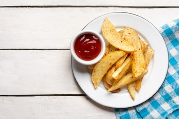 French fries with ketchup sauce on white background
