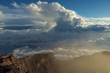 Kerinci volcano summit caldera in early morning high above the clouds in Sumatra, Indonesia