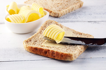 Toasted bread with fresh butter curls. margarine or spread, natural dairy product on breakfast bread