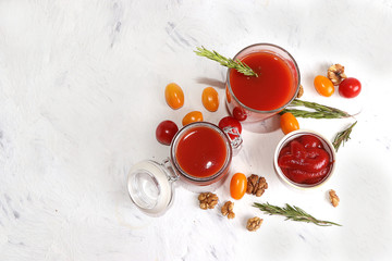 Tomato juice, sauce, pasta and ingredients on a concrete table. The concept of detox diet and weight loss, natural nutrition, healthy and natural foods. Summer drinks, vitamins C