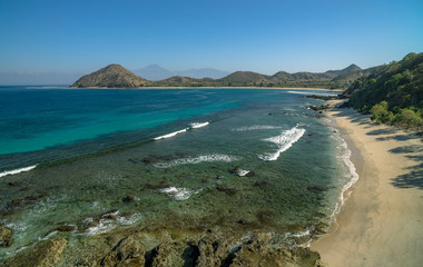 Pristine beach scene with no people or houses and Rinjani volcano in distance shot in Sumbawa Island, NTB, Indonesia