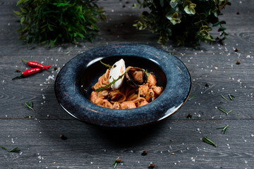 mussels pasta on grey served table. traditional dish menu served in a restaurant