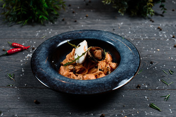 mussels pasta on grey served table. traditional dish menu served in a restaurant