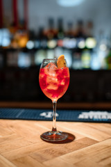 red alcohol cocktail on dark bar