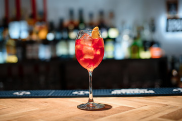 red alcohol cocktail on dark bar